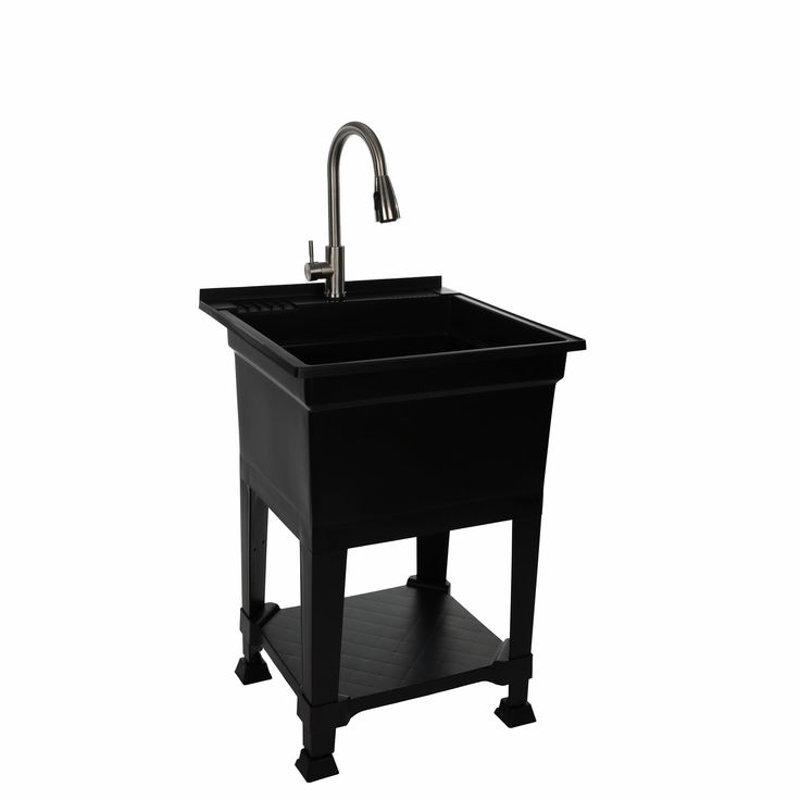 a black sink with a faucet on the side and a metal faucet