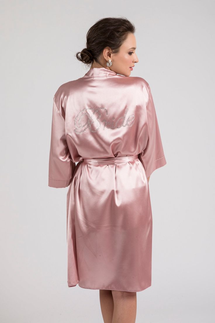 "This 3-pieces set is cut from blush pink soft satin in a kimono-inspired silhouette. It consists of the robe, camisole and shorts. It has a relaxed fit and detachable sash belt to keep it secure. Premium glass rhinestones embellish robe's back with the sparkly graphic \"BRIDE\". Excellent to be worn on the morning of the wedding or the night before your special day. Everyone will love this gorgeous loungewear set and you will look stunning in your getting ready photographs. It is available in S Ivory Heels Wedding, Wedding Platform, Ivory Bridal Shoes, Satin Pyjama, Personalized Robe, Ivory Wedding Shoes, Satin Pajama, Wedding Robe, Rose Blush