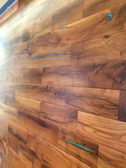 a wooden wall that has been made into a wood paneled wall with blue tape on it