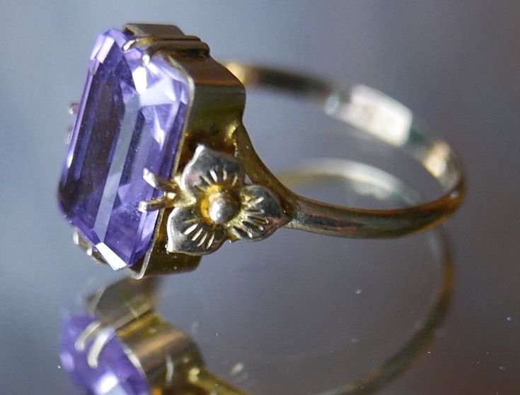 Antique Victorian delicate gold ring with dazzling emerald cut amethyst gemstone in elegant basket setting with belle epoch floral motifs on shank. Photographs cannot do justice to this beautiful piece.  Stamped as shown in photographs. Excellent vintage condition. Ring size: Adjustable, US 7 / 17.5 mm Gemstone length: 1.4 cm ☞ Please view my shipping and sales policies and ✎ Contact me with questions prior to purchase...all sales are final. http://www.etsy.com/shop/Andeebird/policy Luxury Emerald Cut Amethyst Wedding Ring, Elegant Emerald Cut Purple Jewelry, Elegant Purple Emerald Cut Jewelry, Classic Amethyst Ring With Rectangular Stone For Formal Occasions, Rectangular Amethyst Ring For Formal Events, Rectangular Amethyst Ring For Formal Occasions, Elegant Rectangular Amethyst Ring For Formal Occasions, Elegant Purple Amethyst Bezel Setting Ring, Elegant Purple Amethyst Ring With Bezel Setting