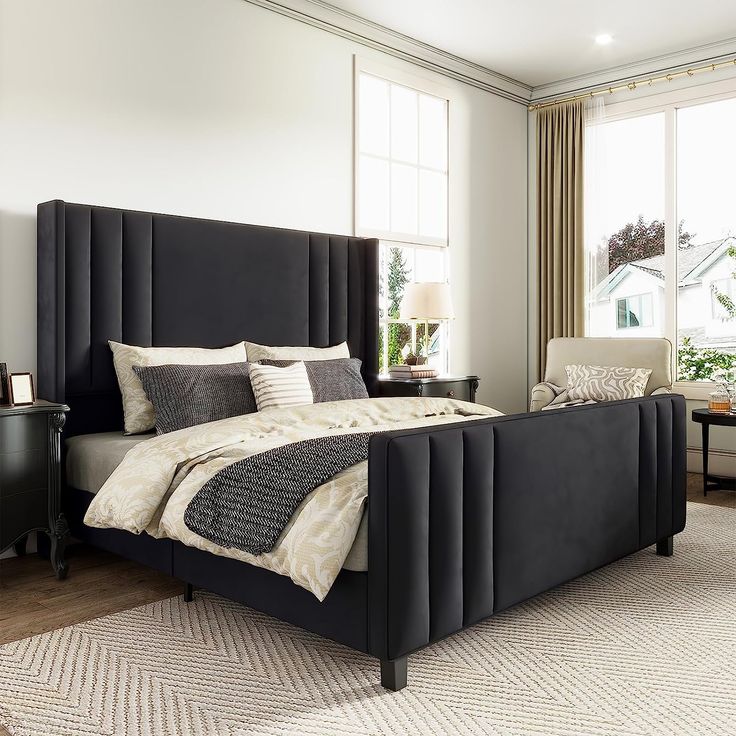 a bedroom with a large bed and two chairs in front of the window, next to a piano