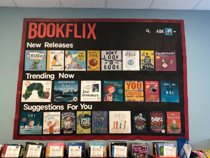 a bulletin board with books on it in front of a blue wall that says bookflix