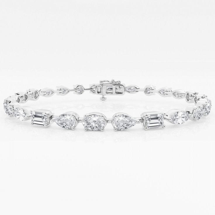 Celebrate the unique beauty of diamond shapes with this striking alternating diamond band. Scintillating oval, pear, marquise, emerald, and round diamonds come together to form an exquisite array of fire, sparkle, and play of light. Whether worn stacked or solo, this eye-catching alternating band is a must-have for true diamond enthusiasts. Luxury Diamond Bracelet With Delicate Chain For Formal Occasions, Luxury Brilliant Cut Lab-grown Diamond Bracelet, Luxury Diamond Bracelets With Intricate Design, Luxury Classic Sterling Silver Bracelet With Diamond Cut, Exquisite Bangle With Diamond Accents, Luxury Dazzling Moissanite Diamond Bracelet, Luxury Statement Diamond Bracelet For Wedding, Luxury Diamond Cut Bangle In Diamond White, Luxury Diamond White Brilliant Cut Bangle