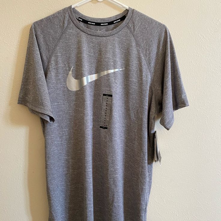 Nike T-Shirt New With Tags Size M Athletic Heather Short Sleeve Athleisure Top, Athletic Heather Short Sleeve Tops For Athleisure, Gray Short Sleeve Sports Top, Nike Athletic Heather Crew Neck T-shirt, Nike Athletic Heather Moisture-wicking Tops, Nike Moisture-wicking Athletic Heather Tops, Nike Gray T-shirt With Logo Print, Nike Gray Tops With Letter Print, Gray Short Sleeve Sports Shirt