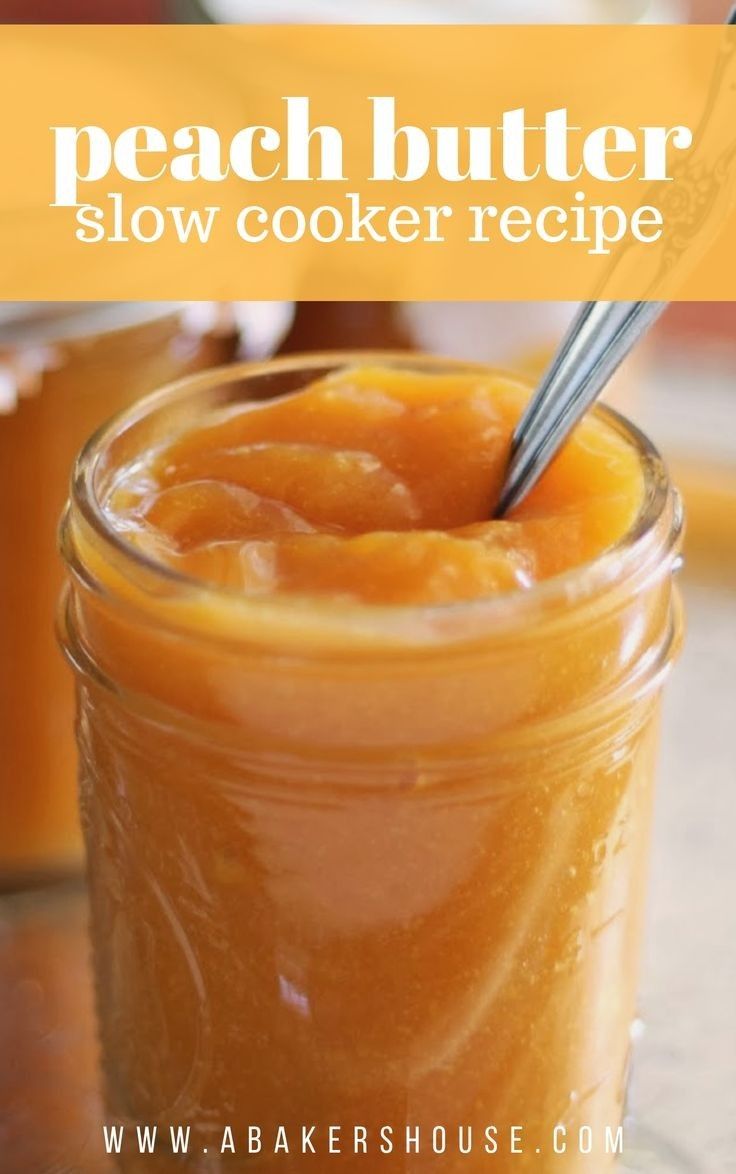 a jar filled with peach butter sitting on top of a table