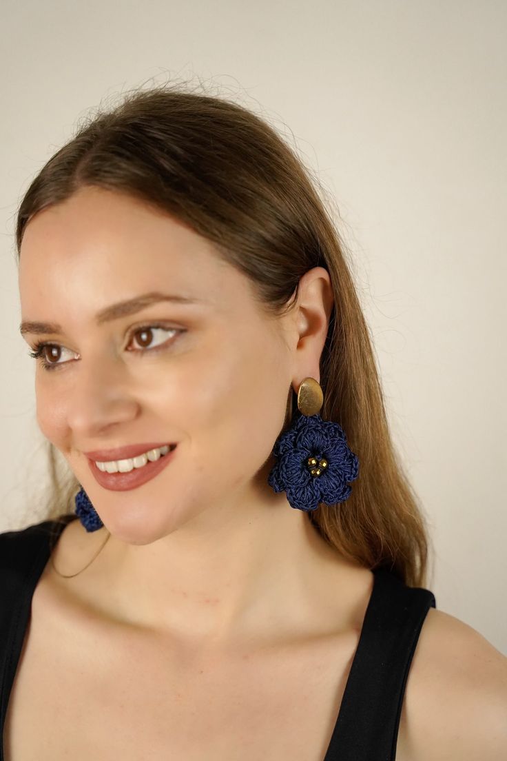 Our signature design-but grand! Awaken your inner Goddess with a stunning pair of hand-crocheted flower earrings in a chic deep blue color. Please note: Small variations in size and shape are expected; these are handcrafted items. Colors may show differently in different screens and lighting. The second model photo is for SIZE reference only, With every purchase, you support postpartum moms and babies in need in the USA. Real gold plated brass posts Design crocheted by hand in the USA Gold-plate Blue Drop Earrings With Handmade Flowers, Handmade Chic Flower Earrings, Blue Handmade Flower-shaped Earrings, Blue 3d Flower Drop Earrings, Blue Handmade Flower Earrings, Handmade Blue Flower Earrings, Handmade Blue Flower Earrings For Party, Blue Elegant Earrings With 3d Flowers, Elegant Blue Earrings With 3d Flowers