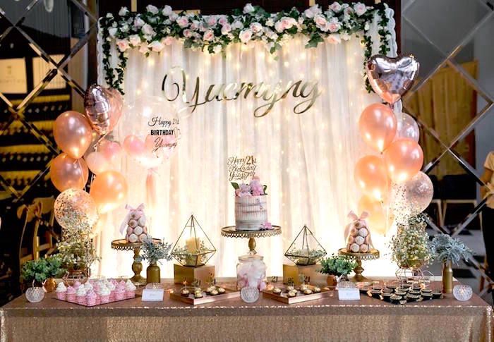 the dessert table is decorated with balloons and cake