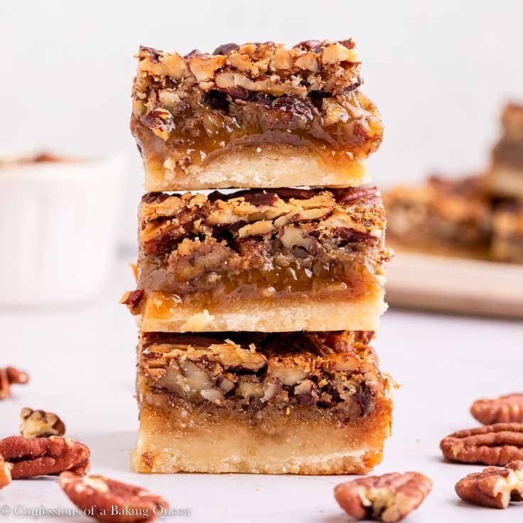 three pieces of pecan bar stacked on top of each other