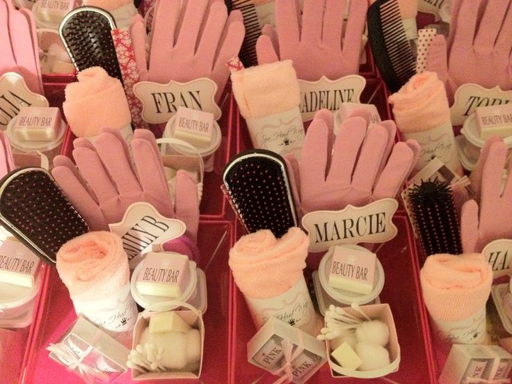 many pairs of pink gloves and hairbrushes are on display in a box together