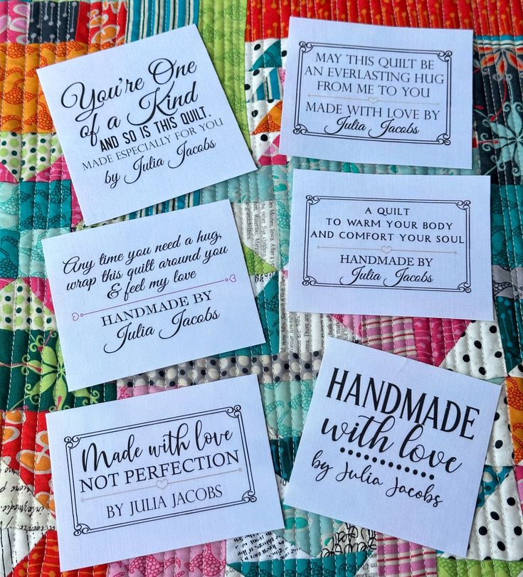 four handmade labels on a quilt