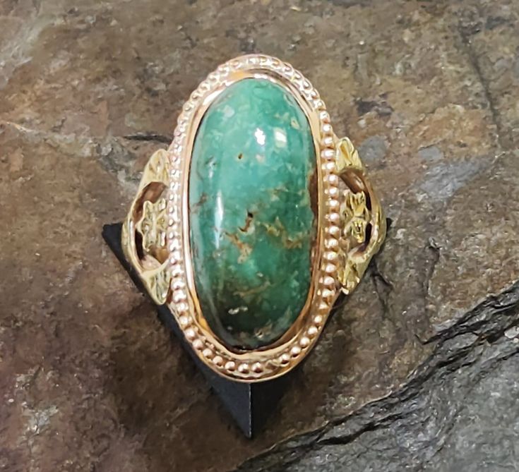 This antique 10 karat gold ring is in amazing condition for its age! It's a size 4 & 1/4, stamped 10K on the inside, and features a bezel-set genuine Turquoise, turned greenish blue with age, in perfect condition. This unusual ring is two tone -the decorative elements on each shoulder are green gold, while the rest of the ring is rosy-yellow gold. This turquoise measures 17 x 8 mm, high domed with an excellent polish.  ~ Gift box included ~ follow Squidnuggets on Instagram for first looks at new work!! Gold Oval Hallmarked Turquoise Ring, Vintage Yellow Gold Turquoise Oval Ring, Vintage Yellow Gold Oval Turquoise Ring, Antique Oval Turquoise Ring Hallmarked, Antique Turquoise Ring In Yellow Gold, Antique Yellow Gold Turquoise Ring For Anniversary, Antique Oval Emerald Ring, Vintage Yellow Gold Turquoise Ring Hallmarked, Antique Turquoise Gemstone Ring For Formal Occasions