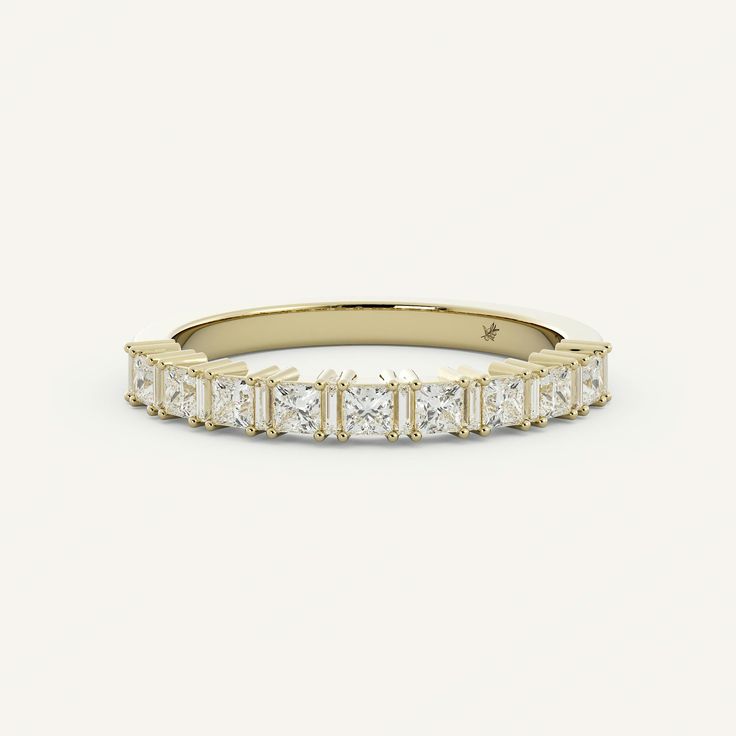 a yellow gold band with princess cut diamonds