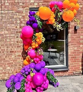 a bunch of balloons that are in front of a building