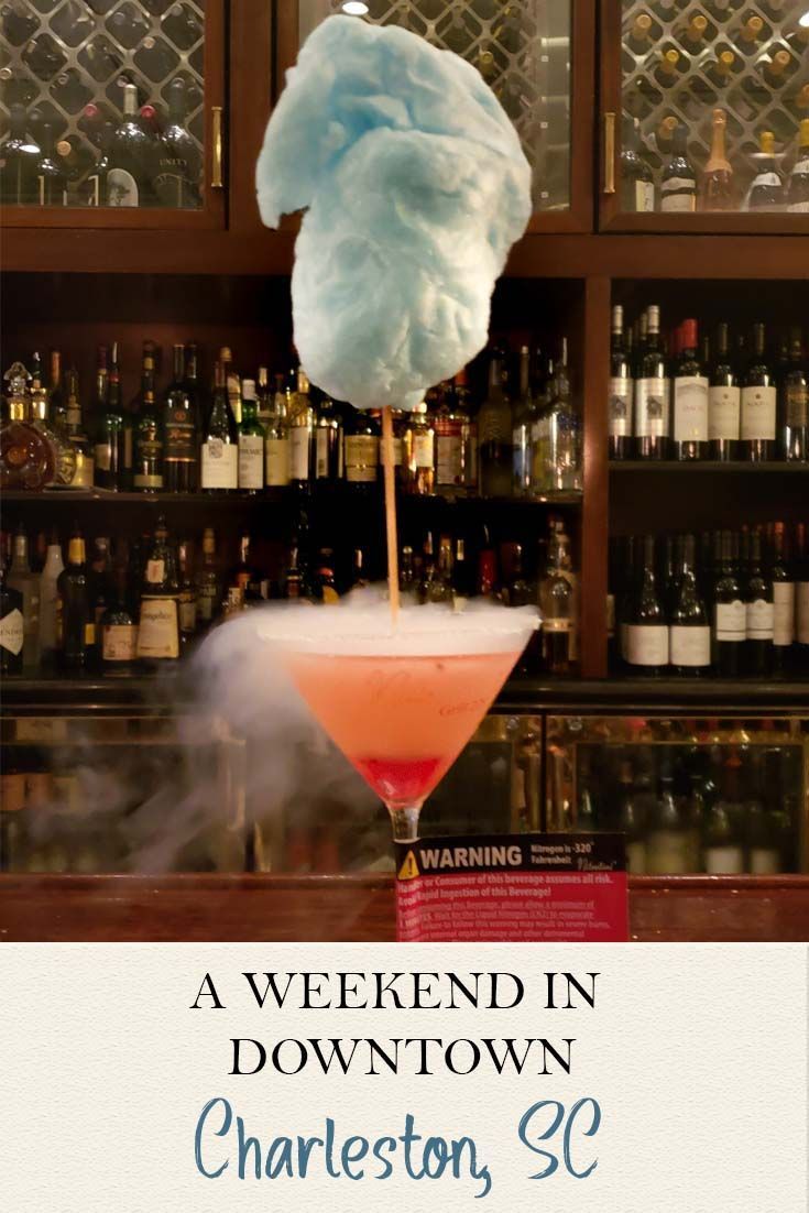 a pink cocktail with a blue cotton candy on top and the words, a weekend in downtown charleston