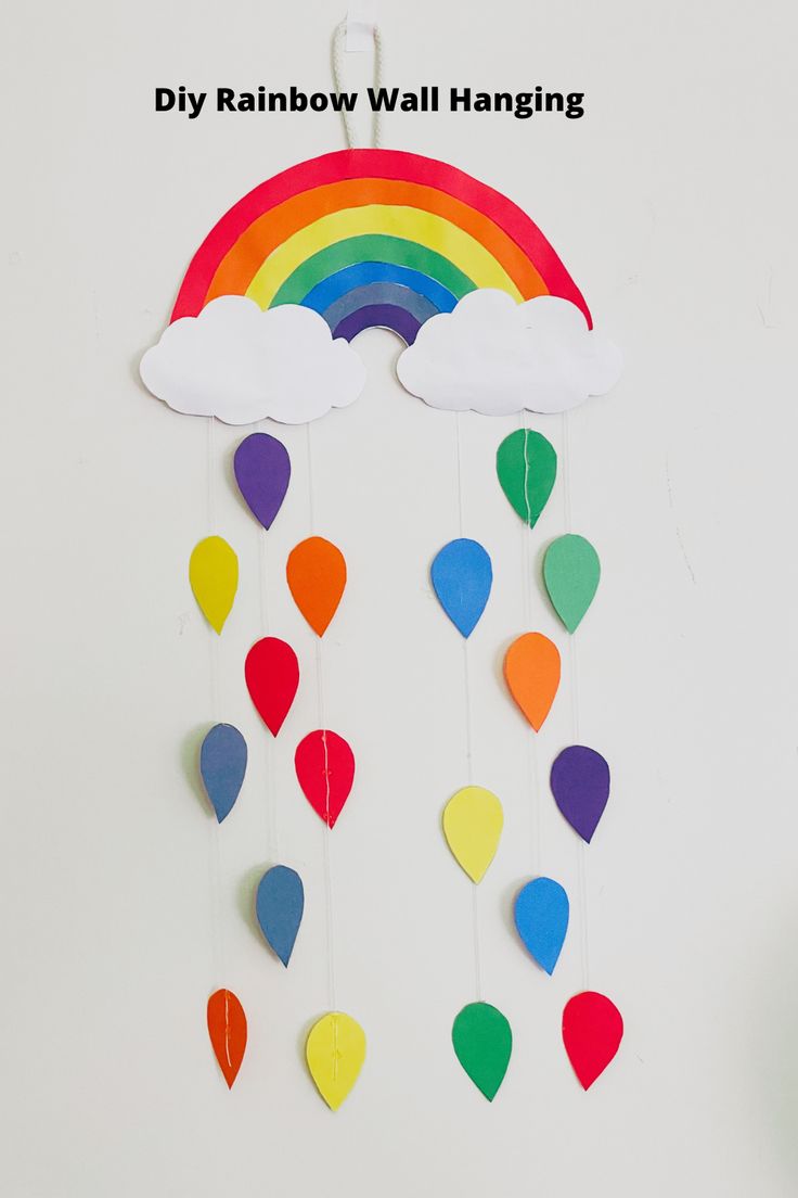 a rainbow wall hanging made out of paper