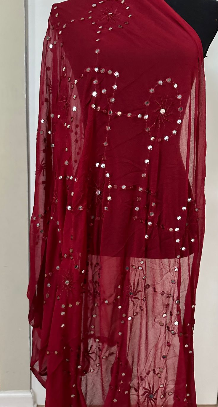 This unique Maroon Dupatta is an excellent addition to any wardrobe. Its intricate mirror detailing adds a touch of glamour to any outfit. Crafted from fine fabric, it is sure to elevate any look. Dry Clean only. Glamorous Embellished Dupatta For Eid, Glamorous Embellished Festive Dupatta, Fitted Sequin Fabric For Festivals, Embellished Dupatta For Party, Glamorous Eid Dupatta With Mirror Work, Glamorous Embellished Dupatta For Festivals, Glamorous Resham Embroidery Dupatta For Party, Glamorous Resham Embroidered Party Dupatta, Glamorous Festive Dupatta With Resham Embroidery