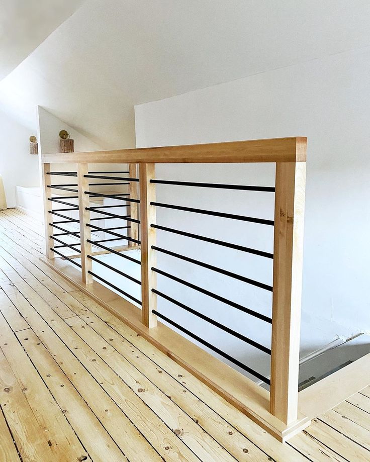 an empty room with wooden floors and railings