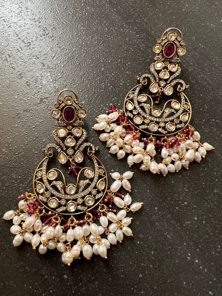 A premium quality kundan stones earrings to elevate the candlelit glamour! Material: Brass and Copper mix, Kundan, CZ Stones , beads , Victorian Polish Notice the zirconia stones bordering the Kundan stones. The necklace and earrings are the same as shown in the pictures. We have only one piece in this color and design, hence you get what you see in the pictures. Festive Stone Work Chandelier Earrings For Reception, Elegant Kundan Bridal Earrings With Stone Work, Temple Jewelry Style Chandelier Earrings For Reception, Festive Chandelier Earrings With Stone Work For Reception, Elegant Kundan Pearl Earrings With Stone Work, Elegant Jeweled Chandbali Pearl Earrings, Traditional Jeweled Pearl Earrings For Party, Elegant Jeweled Chandelier Earrings For Festive Occasions, Elegant Kundan Danglers With Stone Work