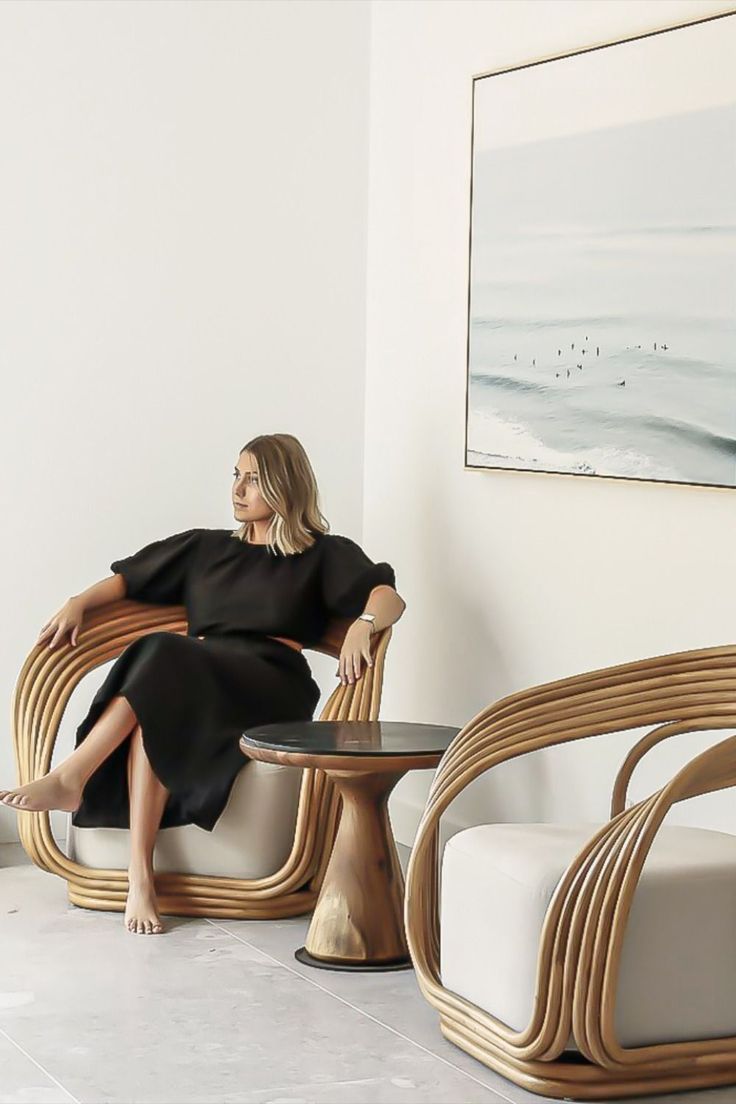 a woman sitting in a chair next to a table