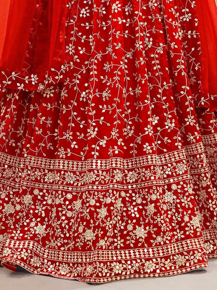 Fill vibrant hues in the upcoming wedding season with our captivating "attractive red embroidered georgette wedding wear lehenga choli" from Ethnic Plus. This stunning red lehenga choli ensemble is the perfect choice for your weddings, receptions, and other special occasions. With its rich red color and intricate embellishments, you are sure to make a lasting impression wherever you go.
The lehenga features a beautiful georgette material adorned with sequin work, zari work, and embroidery detail Red Floor-length Sharara With Zari Work, Unstitched Red Lehenga For Reception, Red Unstitched Lehenga With Traditional Drape, Unstitched Red Lehenga With Traditional Drape, Red Unstitched Lehenga In Traditional Drape, Unstitched Red Lehenga In Traditional Drape, Bollywood Red Unstitched Gown, Red Lehenga With Intricate Embroidery For Eid, Unstitched Red Choli With Intricate Embroidery