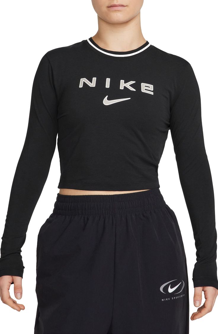 Slim-cut and slightly cropped, this body-skimming T-shirt made with modal and cotton features reflective details to get you noticed day and night. 17" length (size Medium) Crewneck Long sleeves Reflective details enhance visibility in low light or at night 48% modal, 46% cotton, 6% spandex Machine wash, line dry Imported Nordstrom x Nike: A curated lifestyle destination where fashion is the ultimate sport Long Sleeve Elastane Sportswear Tops, Nike Athleisure Tops With Letter Print, Nike Fitted Top With Graphic Print, Fitted Nike Top With Graphic Print, Nike Go-dry Top For Streetwear, Sporty Elastane Tops With Medium Support, Sporty Tops With Medium Support In Elastane, High Stretch Letter Print Top For Athleisure, Stretch Black Tops With Logo Print