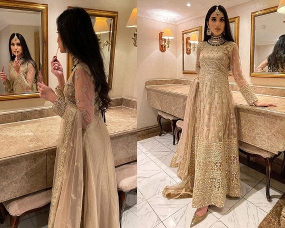 Beige Golden Heavy Designer Work Wedding Special Anarkali Suit is Ready to Look you Gorgeous and Beautiful in the Crowd❤️. Shop Heavy Celebrity Wearing Anarkali Suits, Salwar Kameez, Lehenga, Bridal Lehenga, Gowns, Pakistani Suits, Sarees in the USA, UK, Canada, France, Germany, etc. The Fabric of the Dress is Georgette + Net. Style is Anarkali Suit. Work - Heavy Embroidered. This dress is a Semi-Stitched dress but we have Customization Options also available For that, we've hired the best designers to Stitch your dress perfectly as per your measurements. This set comprises the Anarkali suit with Anarkali, bottom Lehenga/Pant, and dupatta. Size up to: 32(XXS), 34(XS), 36(S), 38(M), 40(L), 42(XL), 44(XXL), 46(XXXL). Designer work is completed with Embroidery Zari, Pearls, And Thread work. G Bollywood Style Maxi Length Wedding Choli, Anarkali Maxi Choli For Wedding, Wedding Anarkali Choli Maxi Length, Gold Maxi Length Salwar Kameez For Wedding, Bollywood Style Churidar For Wedding, Long Lehenga For Wedding And Navratri, Anarkali Choli For Wedding And Eid, Anarkali Choli For Wedding Eid, Bollywood Style Floor-length Wedding Churidar