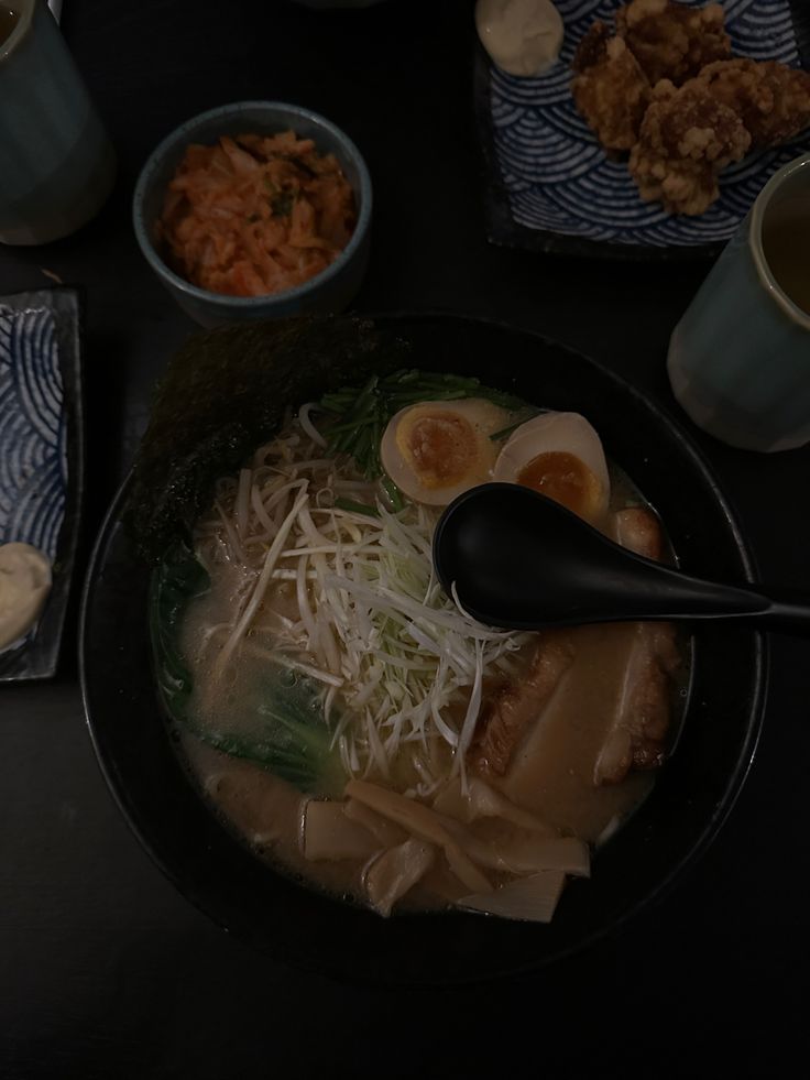 a black bowl filled with food on top of a table