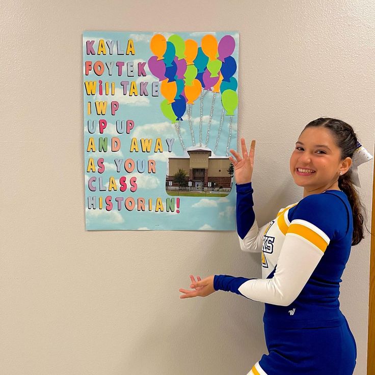 a girl is posing in front of a wall with balloons