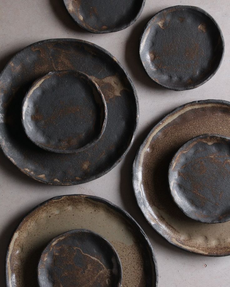 four dirty plates sitting on top of a white counter