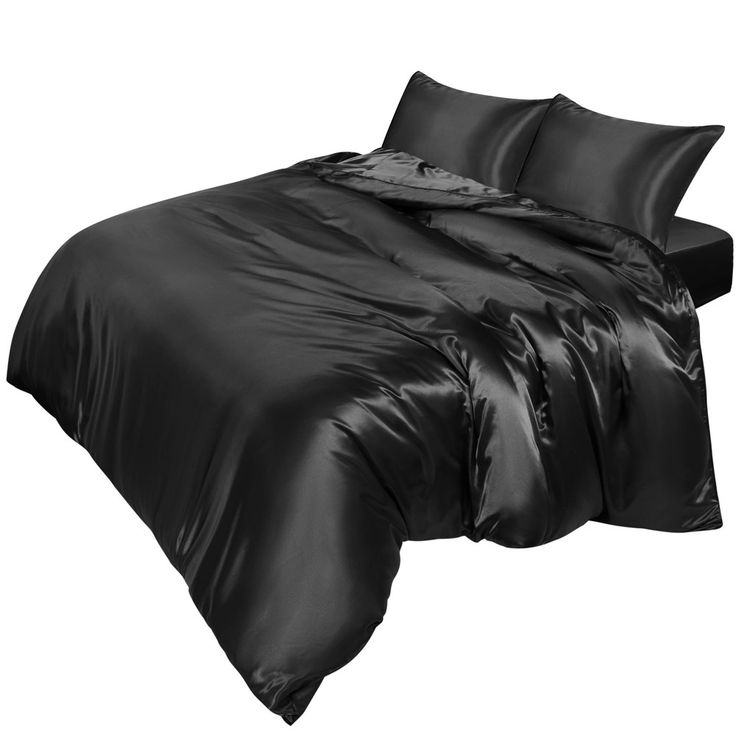 a bed with black sheets and pillows on it's side, in front of a white background