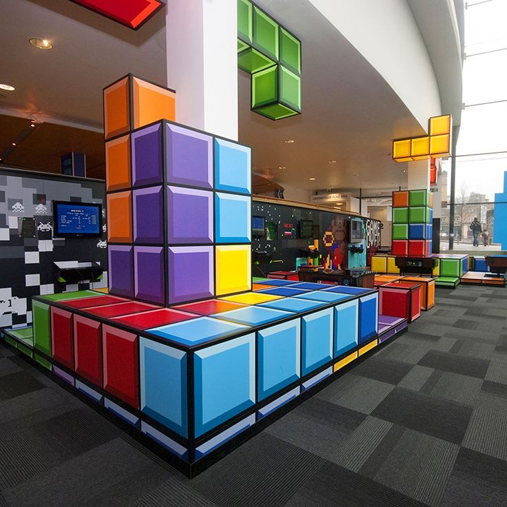 colorful cubes are stacked on top of each other in the middle of an office building