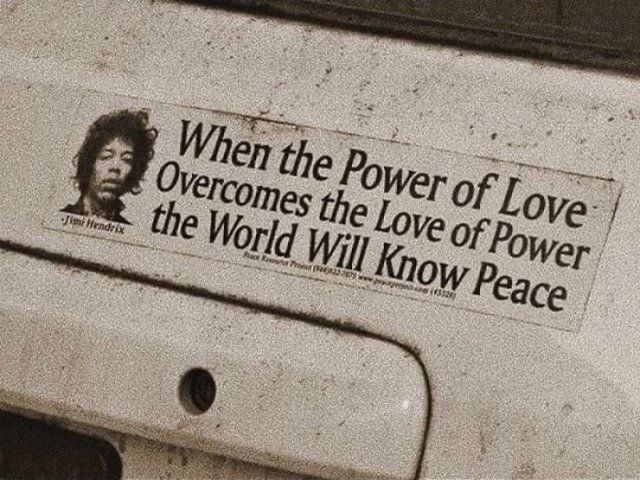 a sticker on the back of a car that says, when the power of love overcomes the love of power, the world will know peace