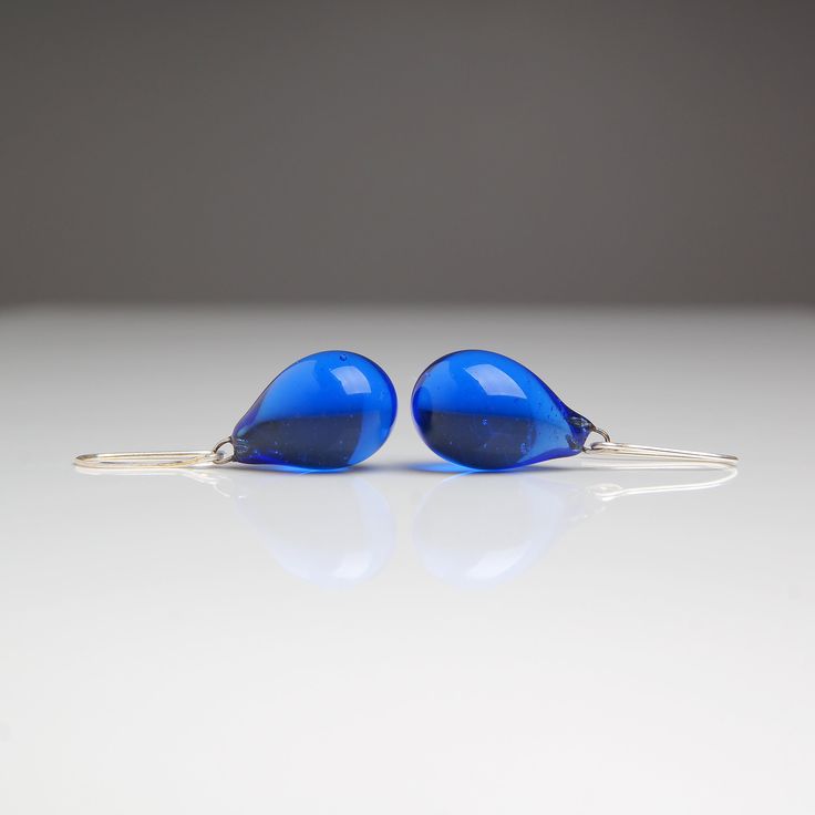 "These Small dark blue teardrop earrings are made of glass in lampwork technique. The earrings hooks are sterling silver and are hypoallergenic. These unique and beautiful earrings are like water drops frozen in glass! They are simple and elegant, very lightweight and comfortable to wear, perfect for everyday wear and for special occasions. 💕 You will definitely receive lots of compliments on your new earrings, everybody loves them, and you'll love them too! Dimensions: total length about 1 1/8 Blue Pear-shaped Teardrop Earrings, Blue Long Drop Teardrop Earrings With Ear Wire, Modern Blue Long Drop Earrings, Minimalist Blue Teardrop Jewelry, Blue Nickel-free Long Drop Teardrop Earrings, Blue Teardrop Pendant Earrings As Gift, Blue Long Drop Teardrop Earrings Gift, Sapphire Teardrop Earrings For Gift, Blue Teardrop Drop Earrings