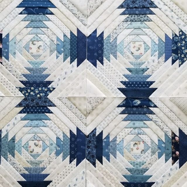 the blue and white quilts are arranged together