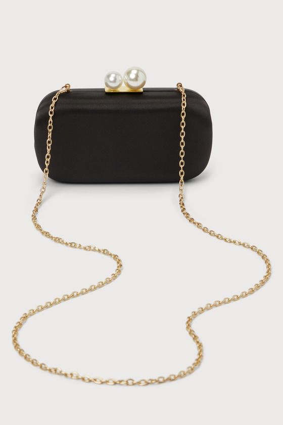 Complete any sophisticated party look with a perfect finishing touch like the Lulus Poised Feelings Black Satin Pearl Box Clutch! Sleek satin shapes this chic box clutch that has a rectangular silhouette and a top clasp closure composed of oversized faux pearl details. The roomy, lined interior with accordion sides is perfect for storing your night-out essentials, while a detachable gold chain allows you to style it as a crossbody! Lined. Bag measures 7. 5" Wide, 4" tall, 2. 25" deep. Chain meas Chic Square Box Bag For Evening, Chic Square Evening Box Bag, Rectangular Box Bag With Chain Strap For Parties, Rectangular Satin Evening Bag For Party, Chic Box Bag For Evening, Sleek Evening Bag For Formal Occasions, Elegant Rectangular Satin Evening Bag, Elegant Satin Rectangular Evening Bag, Party Rectangular Box Bag With Chain Strap