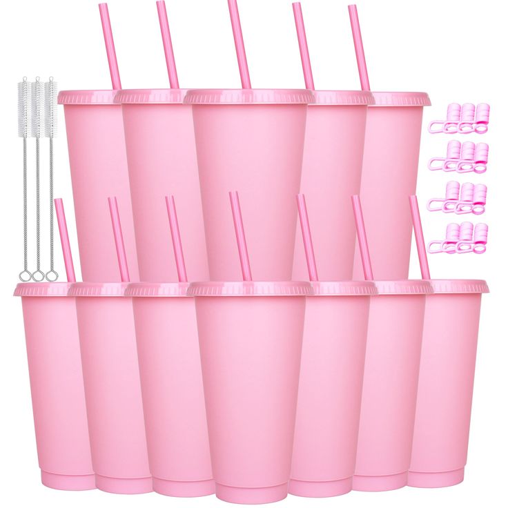 six pink cups with straws and toothbrushes in them are stacked on top of each other