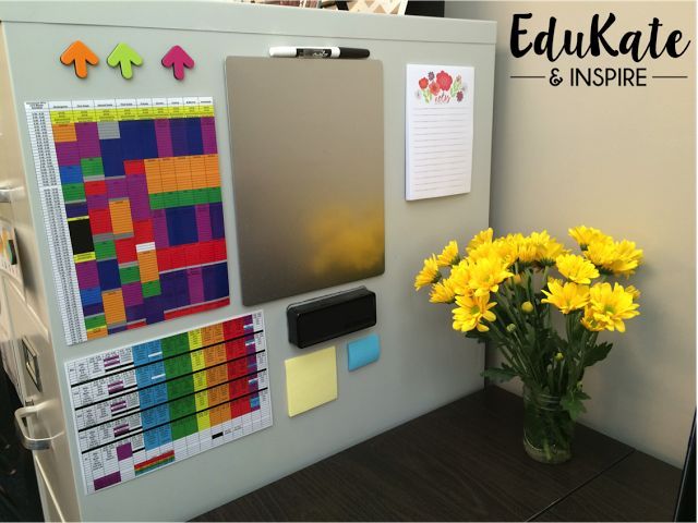 a vase with yellow flowers in it next to a bulletin board that has stickers and magnets on it