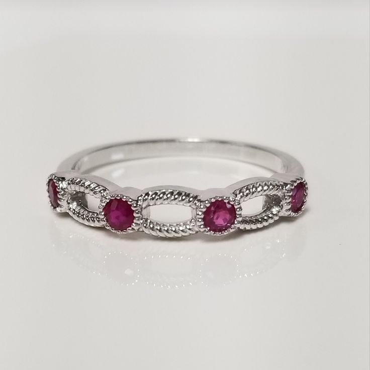 "Thanks for shopping our vintage estate store. We tend to sell well below wholesale and truly hope you enjoy all of our items. Many of the items are one of a kind, so please enjoy scrolling through the pictures and hopefully something will catch your eye. Brown spots are from camera or reflections. Beautiful estate 14k white gold round cut .20ct ruby band. There are 4 rubies for .20ct. Rubies are Burmese and stunning. Ring size: 7 Setting: 3.5mm 1/8\" Weight: 2.0 grams Band width: 1.5mm Marked 1 Formal Ruby Ring With Cubic Zirconia In Round Band, Formal Cubic Zirconia Ruby Ring With Round Band, Formal Cubic Zirconia Ruby Ring, Anniversary Ruby Ring In Diamond White, Diamond White Ruby Ring For Anniversary, Anniversary Diamond White Ruby Ring, Classic Ruby Ring With Prong Setting, Classic Ruby Ring For Promise With Prong Setting, Classic Ruby Cubic Zirconia Promise Ring