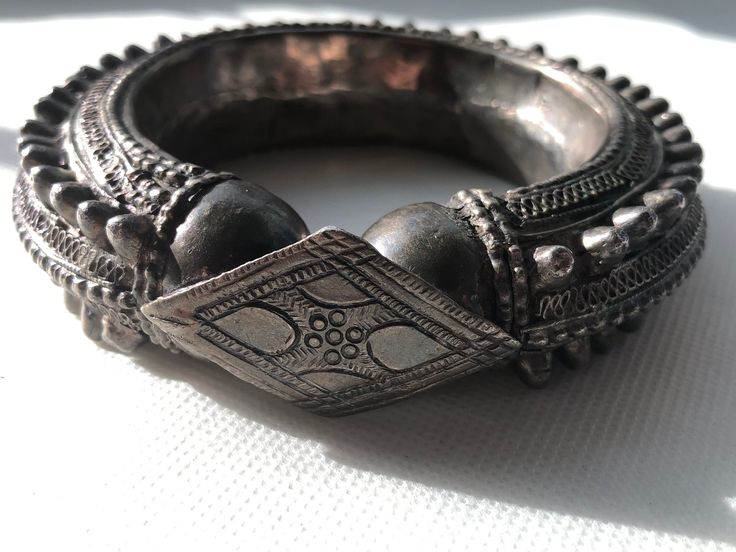 Gorgeous Hefty Ethnic Tribal Spiked Yemeni silver bracelet/bangle with very intricate workmanship and in very good condition with no broken or missing spikes. Collectors piece made in the early 1900s by tribes in Southern Arabia and Northern Africa. These type of bracelets are perfectly wearable and were often given on the occasion of the wedding to the bride  Dimensions: outer diameter 4.5" _  inner diameter 2.5" outer circumference 13.5"  _  inner wearable circumference 8"  1" tall  _  Weighs 163.7 Grams Any questions please ask! Shipped with USPS First Class Package.  Handsome African design.  Please browse the gallery to see our inventory.  Just Gorgeous!  Please refer to photos for more details on markings, size and condition. All weights, measurements and colors are approximate and m Antique Silver Bracelet For Festivals, Metal Bangle With Intricate Design For Festival, Antique Silver Bangle Bracelets For Festivals, Traditional Metal Bracelets For Festivals, Traditional Antique Silver Bracelet For Festive Occasions, Heavy Silver Bracelet For Festivals, Antique Silver Oxidized Bracelets For Rituals, Antique Silver Bracelets For Festivals, Antique Silver Bracelets With Oxidized Finish For Festivals