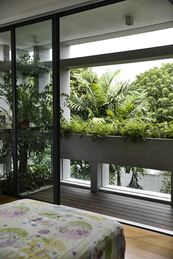 a bedroom with plants in the window sill and a bed on the floor next to it