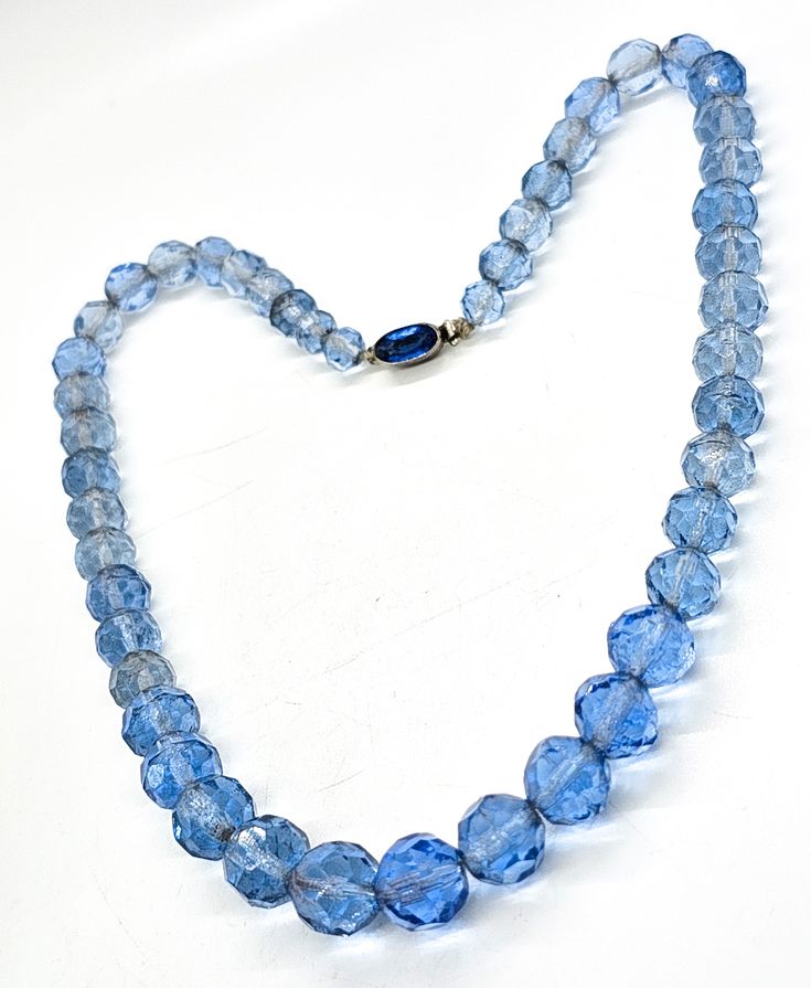 Blue Austrian crystal Czechoslovakia signed Czech glass vintage beaded necklace. Good vintage condition with little signs of normal vintage wear. Silk beaded graduated blue crystal beads have a rhinestone box clasp. Stamped Czechoslovakia on the back of the clasp. Necklace measures 16.5 inches long. Vintage Blue Single Strand Necklace, Vintage Blue Glass Beaded Necklaces, Vintage Blue Single Strand Jewelry, Vintage Glass Faceted Beads, Vintage Blue Single Strand Beaded Necklace, Vintage Blue Single Strand Beaded Necklaces, Vintage Crystal Necklace With Round Beads, Vintage Blue Round Beaded Necklace, Vintage Blue Beaded Necklaces With Spacer Beads