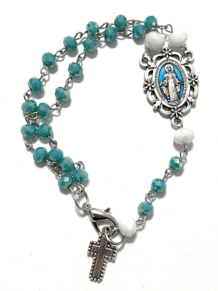 Details: I am excited to present this beautiful hand beaded Religious Rosary I designed. I always love learning new techniques to create amazing & unique gifts for my customers! Rosary symbolizes a chain of roses and the roses are prayers. The Rosary Prayer tells us about the life of Jesus and his Mother, Mary. If you want to purchase one similar to this or have me customize a design for you please contact me: info@madarifashions.com. We can include your favorite sports teams, inspirational word Adjustable Beaded Chain Rosary Bracelet Gift, Bohemian Rosary Bracelet With Faceted Beads As Gift, Bohemian Rosary Bracelet With Faceted Beads, Turquoise Rosary Bracelet Gift, Turquoise Rosary Bracelet With Round Beads As Gift, Czech Glass Beaded Chain Jewelry For Gift, Czech Glass Beaded Chain Jewelry Gift, Adjustable Rosary With Oval Beads As Gift, Handmade Turquoise Rosary Bracelet As Gift