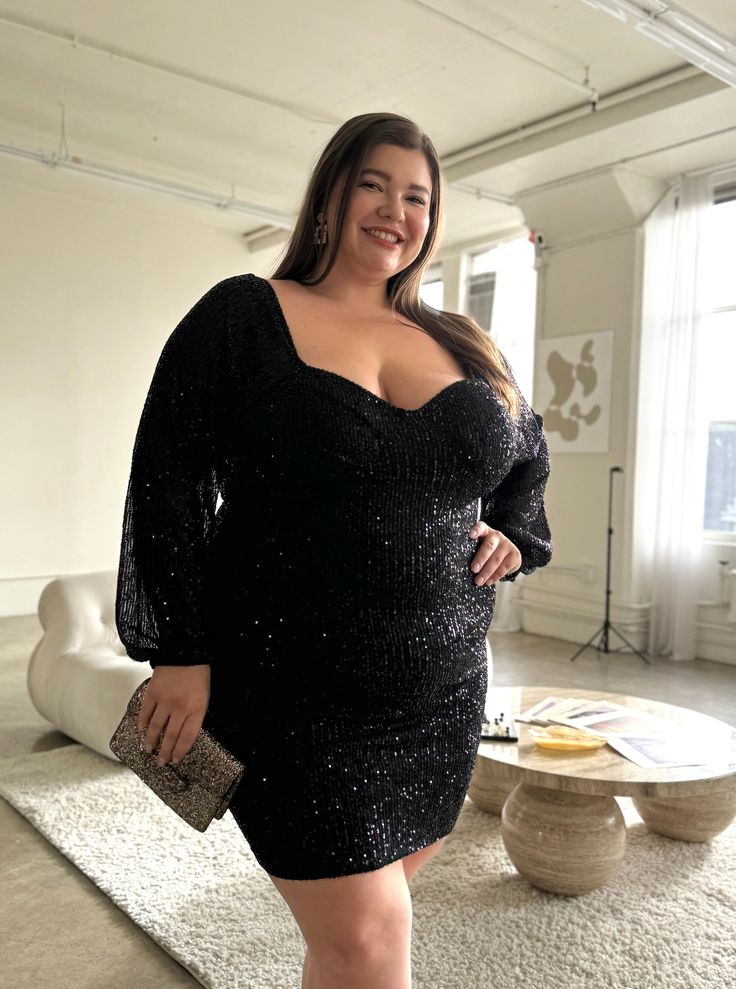 The Plus Size Sparkly Sequin Bodycon Mini Dress is an alluring must-have for your wardrobe! Because it's made out of a dazzling fabric covered in glittery sequins, you're sure to stand out in this dress. Sultry and fun, this feminine piece is sure to turn heads and make a statement! This dress features long sleeves, a padded bust, a zipper down the back, elastic hems, and sequins all over. The material is a stretchy, glittery material. It is made out of 95% Polyester and 5% Spandex. Imported. Ha Feminine Outfits, Big Women Fashion, Plus Size Bodycon, Full Figured, Night Outfits, Bodycon Mini Dress, Fabric Covered, Mini Black Dress, Date Night Outfit