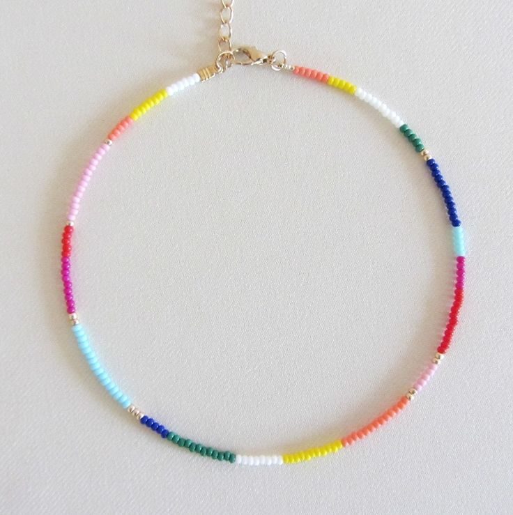 Beaded choker rainbow bead choker choker necklace hippie colorful choker boho chokers seed bead choker colorful beaded choker beach jewelry  These are multi-colored, opaque shiny beads of size 10/0. Please choose the length of the necklace clasp color from the drop down menu or request any length. Each necklace has a 2 inch extension chain. Summer Spacer Bead Choker Jewelry, Summer Beaded Chain Choker Jewelry, Summer Beaded Chain Choker, Summer Beaded Choker Jewelry, Handmade Rainbow Jewelry For Summer, Summer Heishi Bead Jewelry With Tiny Beads, Adjustable Rainbow Choker Jewelry, Summer Choker With Spacer And Round Beads, Rainbow Beaded Necklaces For Summer Festivals