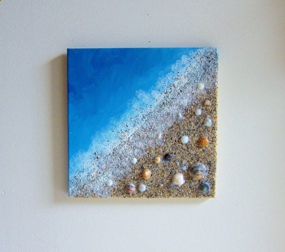 a piece of art that looks like sand and seashells on the beach with blue sky in background