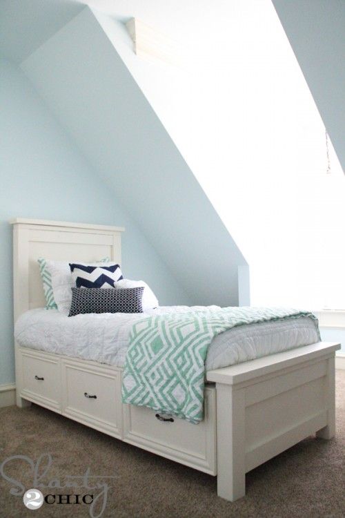 a white bed sitting in a bedroom next to a window with the words diy storage bed on it