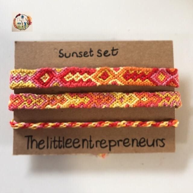 three bracelets with different colors and designs on them, sitting next to each other