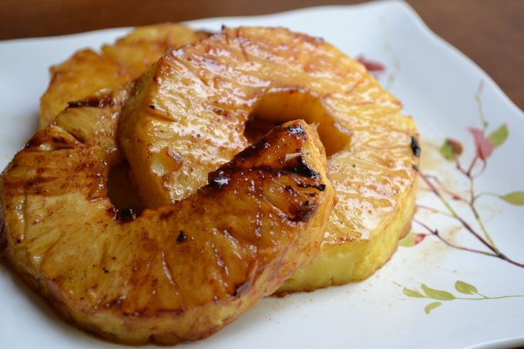 two pieces of pineapple sitting on top of a white plate