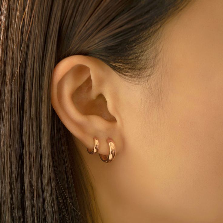 Bold 14K Rose Gold small huggie earring with a thick width. Perfect to wear alone or stacked with other huggies in our collection. 14K Rose Gold Hypoallergenic, lead and nickel free Width 3mm Inside Diameter:6mm, 7.5mm Click close mechanism #ES034-6RGx1 Gold Hoop Earrings Double Piercing, Good Huggie Earrings, 2 Ear Piercings Ideas Simple Gold, Mini Hoops Earrings, Small Gold Hoops Earrings, Gold Mini Hoop Earrings, Mini Earrings Gold, Sleek Gold Earrings, Rose Gold Huggie Earrings