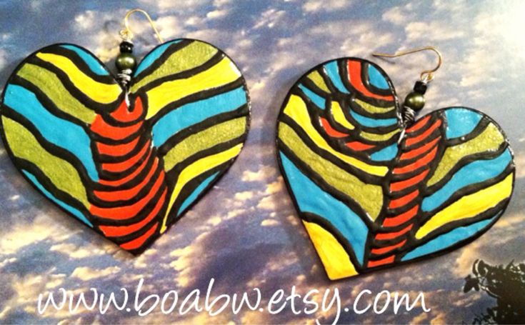 These earrings are hand painted with acrylic paints on lightweight wood and glossed with a clear gloss for protection.. Ear hooks are stainless steel Size 2.5 in long Handmade Multicolor Bohemian Heart Earrings, Bohemian Multicolor Handmade Heart Earrings, Artistic Earrings For Festivals, Artistic Handmade Heart Earrings For Gift, Artisan Multicolor Heart Earrings, Artisan Multicolor Heart-shaped Earrings, Afro Earrings, Peace Earrings, Africa Earrings